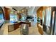 A bright and airy kitchen includes wood cabinets, stainless appliances, and island cooktop, opening to the living area at 5041 Portraits Pl, Las Vegas, NV 89149