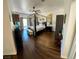 Bright main bedroom with wood floors, large bed, and access to the outside at 5041 Portraits Pl, Las Vegas, NV 89149