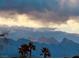 Striking mountain range backdrop with silhouetted palm trees against a dramatic cloudy sky at 5041 Portraits Pl, Las Vegas, NV 89149