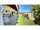 Outdoor patio with artificial turf, an outdoor kitchen, and views of the golf course at 5041 Portraits Pl, Las Vegas, NV 89149