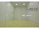 Indoor racquetball court with glass doors, white walls, and wooden floor, exclusively for Painted Desert homeowners at 5041 Portraits Pl, Las Vegas, NV 89149