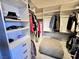 Spacious walk-in closet with custom shelving and an ottoman at 5041 Portraits Pl, Las Vegas, NV 89149