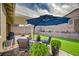 Charming backyard featuring ample seating and landscaping with artificial grass and hardscape at 505 Sterling Falls Ave, Henderson, NV 89011