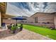 Inviting backyard offers an artificial lawn, a covered patio, and mature landscaping at 505 Sterling Falls Ave, Henderson, NV 89011