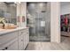 Modern bathroom with double sinks, white cabinets, a tiled walk-in shower, and neutral decor at 505 Sterling Falls Ave, Henderson, NV 89011