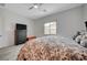 Comfortable bedroom with wood-look tile floors, dark wood furniture, and bright natural light at 505 Sterling Falls Ave, Henderson, NV 89011