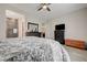 Cozy bedroom showcasing wood-look tile floors, dark wood furniture, and a glimpse into the Primary bathroom at 505 Sterling Falls Ave, Henderson, NV 89011