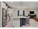 Bright, open kitchen with stainless steel appliances, a central island, and views of the living area at 505 Sterling Falls Ave, Henderson, NV 89011