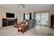 Cozy living room with a fireplace, a large sliding glass door to the backyard, and comfortable seating at 505 Sterling Falls Ave, Henderson, NV 89011