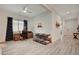 Bright and airy living room featuring wood-look tile floors, neutral walls, and natural light from a window at 505 Sterling Falls Ave, Henderson, NV 89011