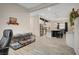 Open-concept living space featuring wood-look tile floors, a modern kitchen, and stainless steel appliances at 505 Sterling Falls Ave, Henderson, NV 89011