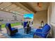 Relaxing covered patio with comfortable seating and a view of the landscaped yard at 505 Sterling Falls Ave, Henderson, NV 89011