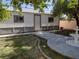 Backyard featuring a white and gray shed with a water feature and concrete pathway at 5204 Padua Way, Las Vegas, NV 89107