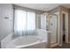 Bright bathroom showcasing a soaking tub and separate glass-enclosed shower at 5204 Padua Way, Las Vegas, NV 89107