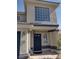 Up close shot of the house's entrance, revealing a navy-blue front door and large, bright window at 5204 Padua Way, Las Vegas, NV 89107