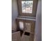 View of entryway and stairs, with gray walls, light fixture and natural light from a high window at 5204 Padua Way, Las Vegas, NV 89107