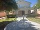 The front yard boasts a water feature and lots of green shrubbery at 5204 Padua Way, Las Vegas, NV 89107