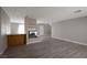 Bright living room with wood laminate flooring, a fireplace, and a view into the kitchen at 5204 Padua Way, Las Vegas, NV 89107