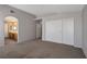 Spacious main bedroom with plush carpeting and an ensuite bathroom at 5204 Padua Way, Las Vegas, NV 89107