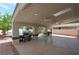 Spacious covered patio with ceiling fans, a grill, and access to the backyard, perfect for outdoor entertaining at 5204 Padua Way, Las Vegas, NV 89107