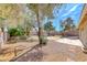 Large backyard landscaped with desert plants and mature trees providing ample shade at 5257 Sunbury Ave, Las Vegas, NV 89122