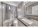 Bathroom featuring a shower-tub combo with a shower curtain, tiled walls, and a granite vanity at 5257 Sunbury Ave, Las Vegas, NV 89122