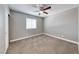Neutral bedroom with gray walls, carpet, white baseboards, a window, and a ceiling fan at 5257 Sunbury Ave, Las Vegas, NV 89122