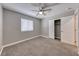 Neutral bedroom with carpeting, gray walls, a window and a closet with double doors at 5257 Sunbury Ave, Las Vegas, NV 89122