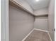 Walk-in closet featuring custom shelving and neutral carpeting at 5257 Sunbury Ave, Las Vegas, NV 89122