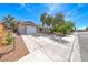 Single-story home with desert landscaping and an extended driveway leading to the garage at 5257 Sunbury Ave, Las Vegas, NV 89122