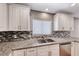 Well-lit kitchen featuring granite countertops, stainless steel appliances, mosaic backsplash, and modern fixtures at 5257 Sunbury Ave, Las Vegas, NV 89122