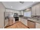 Modern kitchen featuring stainless steel appliances, granite countertops, a mosaic backsplash, and white cabinets at 5257 Sunbury Ave, Las Vegas, NV 89122