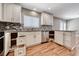 Bright kitchen featuring white cabinetry, mosaic backsplash, granite countertops, and stainless steel appliances at 5257 Sunbury Ave, Las Vegas, NV 89122