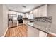 Modern kitchen boasts stainless appliances, granite countertops, and a stylish backsplash at 5257 Sunbury Ave, Las Vegas, NV 89122