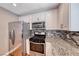 Kitchen with stainless steel appliances, granite countertops, mosaic backsplash, and white cabinets at 5257 Sunbury Ave, Las Vegas, NV 89122