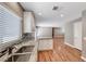 Bright kitchen featuring granite countertops, a modern sink, wood-look flooring and an eat-in dining area at 5257 Sunbury Ave, Las Vegas, NV 89122