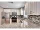 Close-up of the updated kitchen featuring stainless steel appliances and granite countertops at 5257 Sunbury Ave, Las Vegas, NV 89122