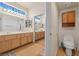 Well-lit bathroom with double sinks, vanity, tile floor, and wooden cabinetry at 5317 Marietta Ave, Las Vegas, NV 89108