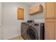 Efficient laundry room featuring modern washer and dryer units with convenient cabinet storage at 5317 Marietta Ave, Las Vegas, NV 89108