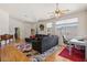 Bright living room with large windows, modern ceiling fan, and open access to other areas at 5317 Marietta Ave, Las Vegas, NV 89108