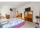 Spacious bedroom featuring a king bed, TV on shelving, and ample natural light at 5317 Marietta Ave, Las Vegas, NV 89108