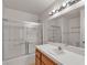 Bathroom featuring a shower over tub, a tiled countertop and a large mirror at 5400 Paul Kurtz Way # 105, Las Vegas, NV 89108