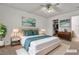 AI-staged carpeted bedroom with a ceiling fan, stylish decor, and a closet at 5400 Paul Kurtz Way # 105, Las Vegas, NV 89108