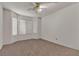 Spacious bedroom with carpeted floors, bay windows, and a ceiling fan at 5400 Paul Kurtz Way # 105, Las Vegas, NV 89108