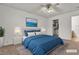 AI-staged modern bedroom featuring blue bedding and colorful wall art at 5400 Paul Kurtz Way # 105, Las Vegas, NV 89108
