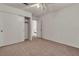 A carpeted bedroom with a ceiling fan and an open closet with sliding doors at 5400 Paul Kurtz Way # 105, Las Vegas, NV 89108