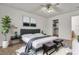 AI-staged bedroom with modern gray bed, decor and a ceiling fan at 5400 Paul Kurtz Way # 105, Las Vegas, NV 89108