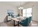 AI Staged dining room featuring seating for four and sliding glass doors to outdoor space at 5400 Paul Kurtz Way # 105, Las Vegas, NV 89108