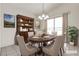 AI Staged dining room featuring an oval table, decor, and views through the sliding glass doors at 5400 Paul Kurtz Way # 105, Las Vegas, NV 89108