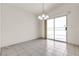 Empty dining area with sliding glass door to the patio, chandelier, and tile flooring at 5400 Paul Kurtz Way # 105, Las Vegas, NV 89108